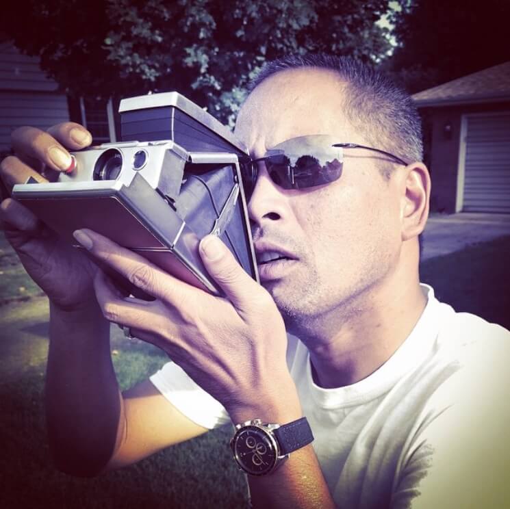 Alex goofing around with an old polaroid camera.