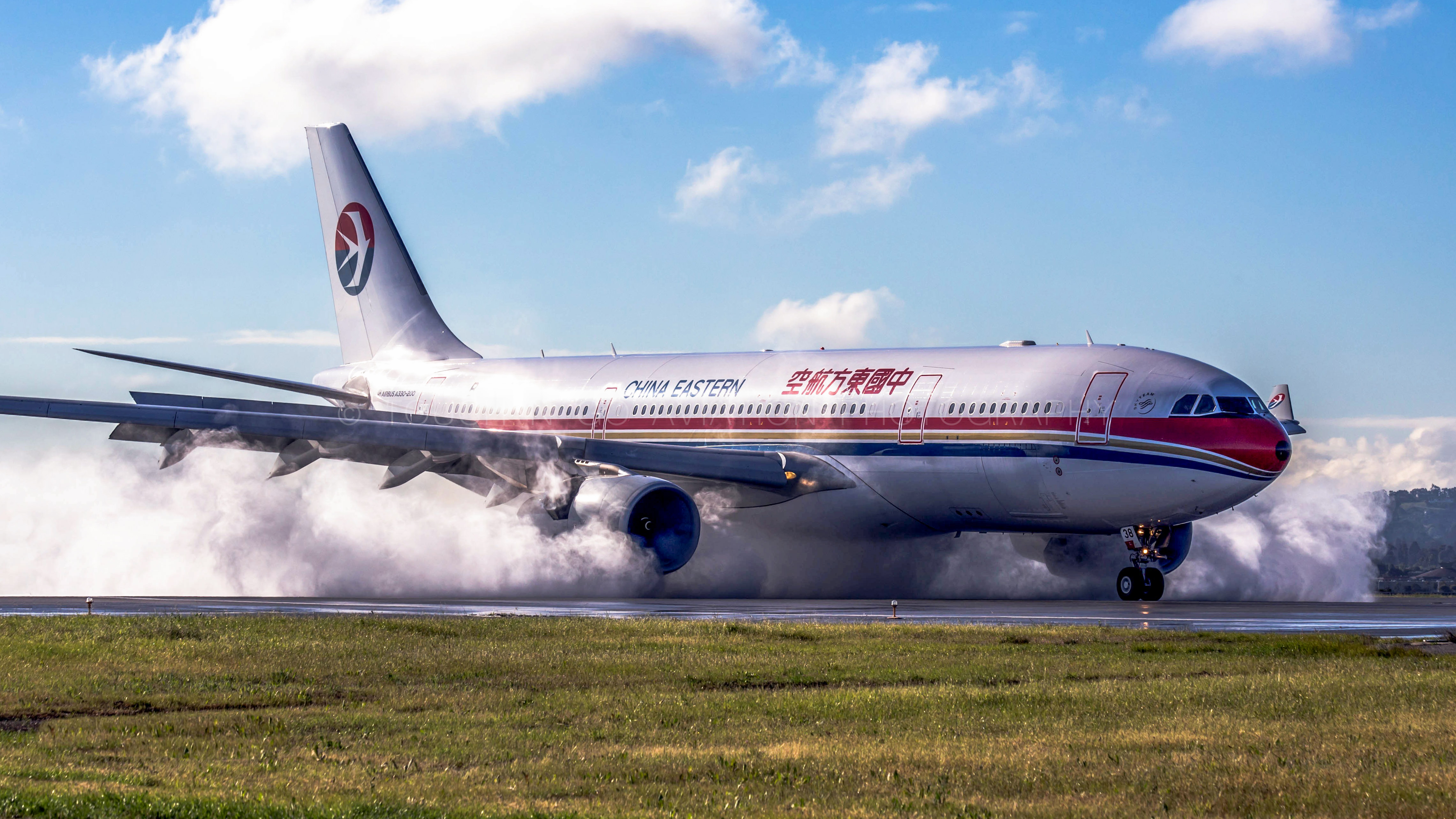China Eastern making a huge water spray upon touchdown into SFO on what had been a rainy morning.