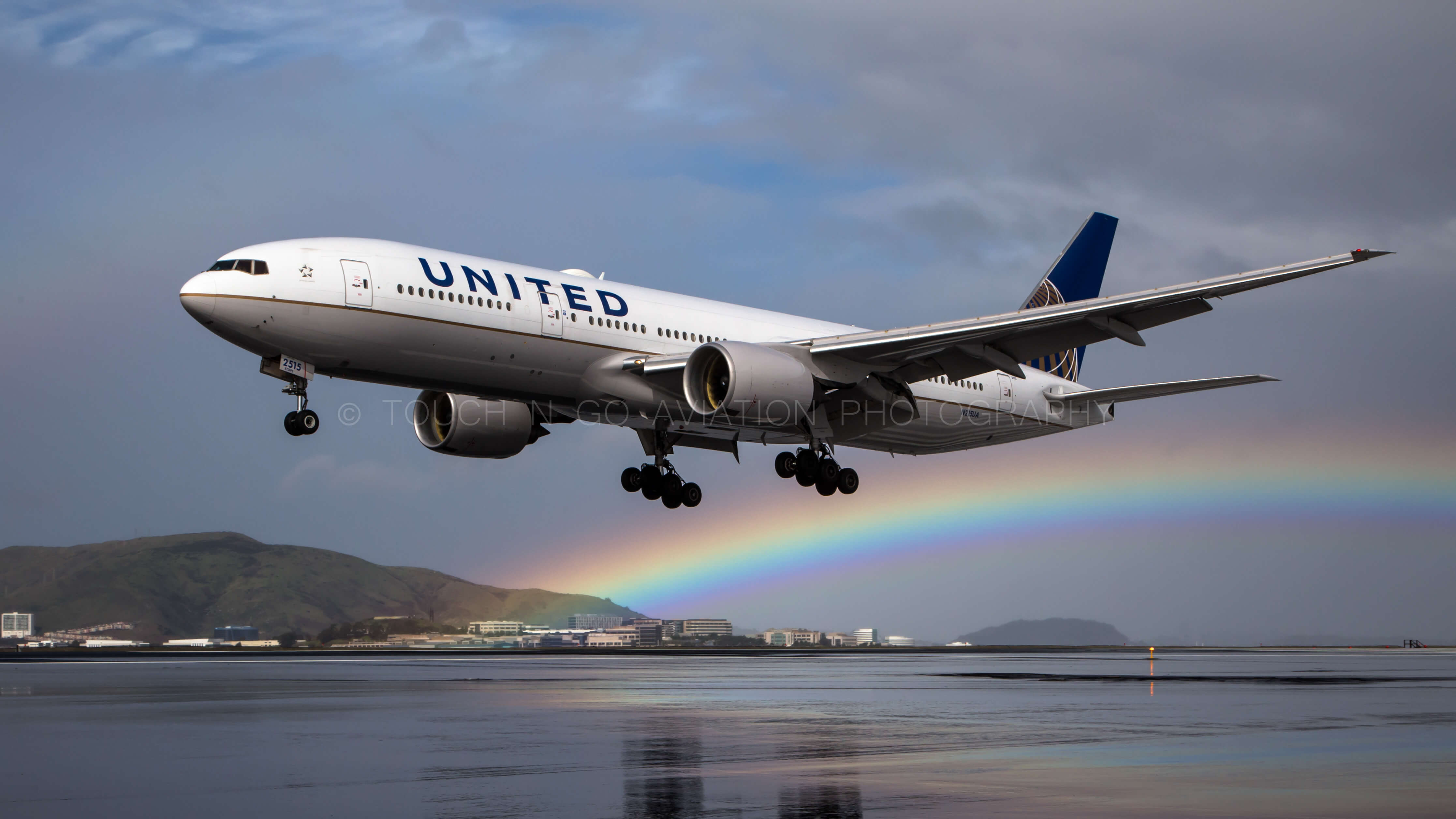 UA arriving into SFO with a rainbow in the background.