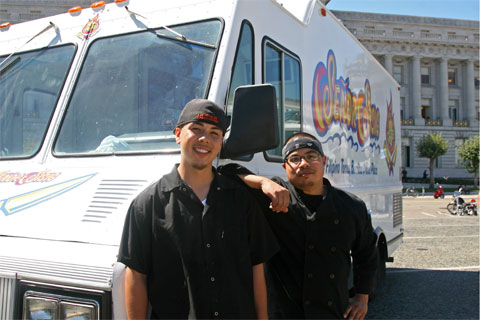 Founders Gil and Even in front of their food truck.