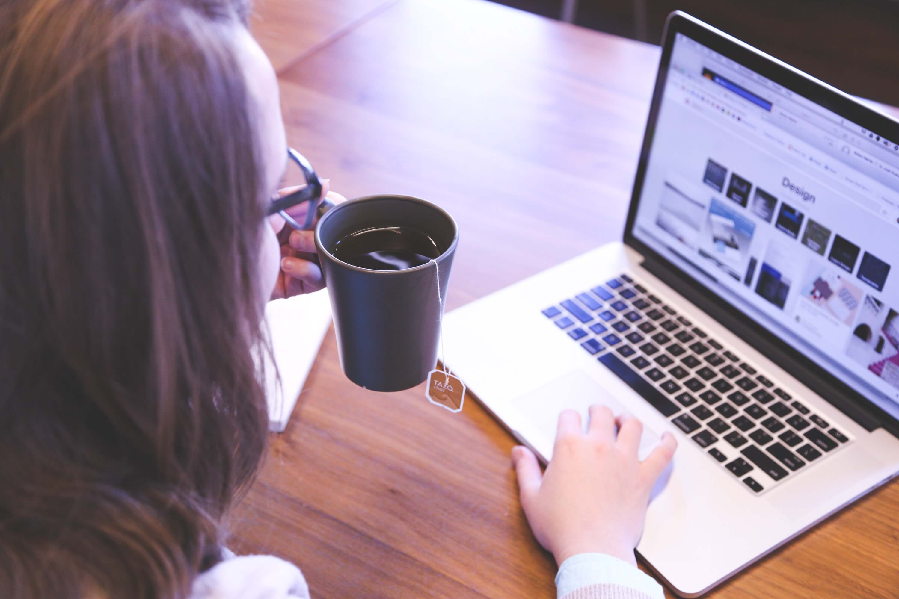woman typing on macbook