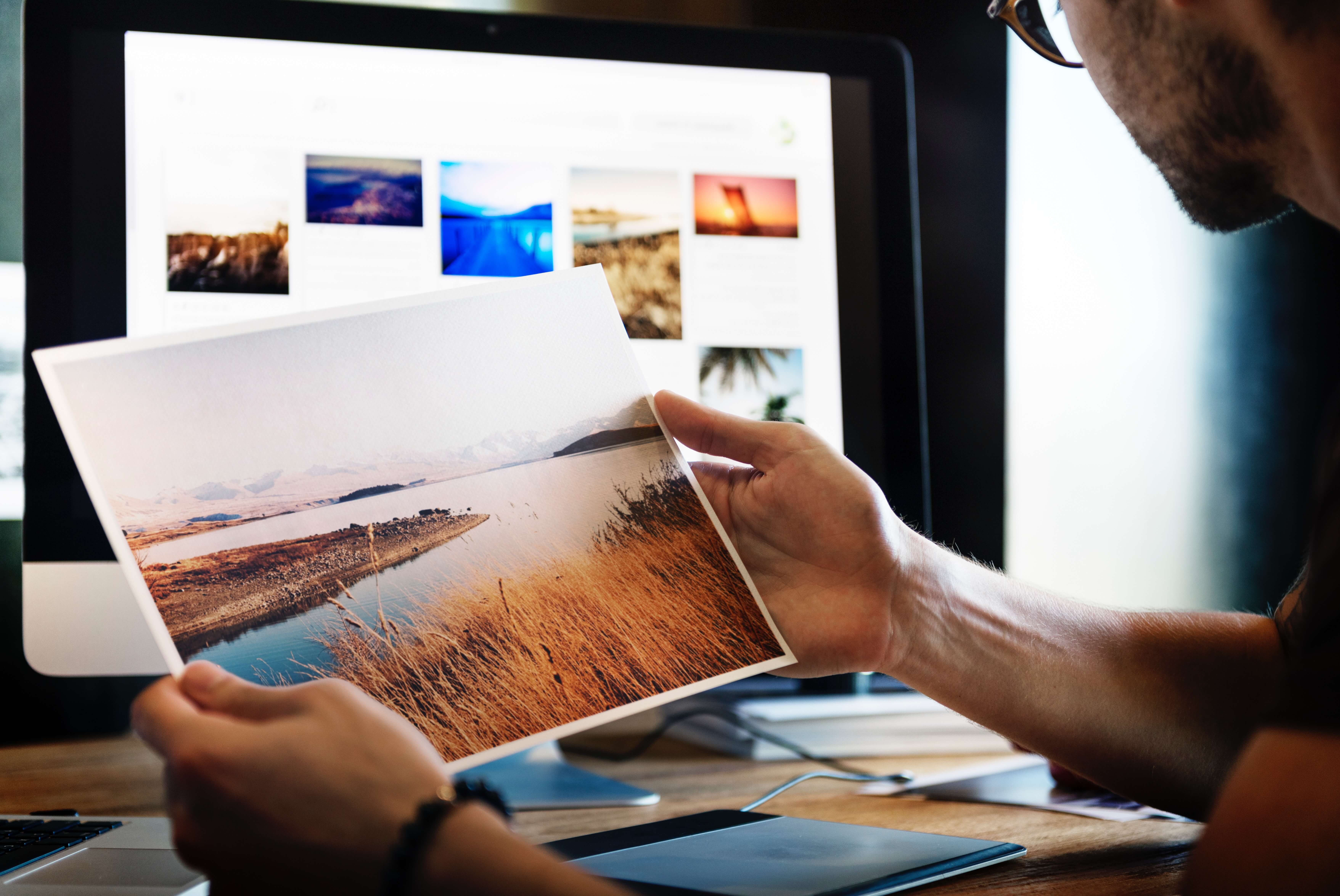man looking at printed photo