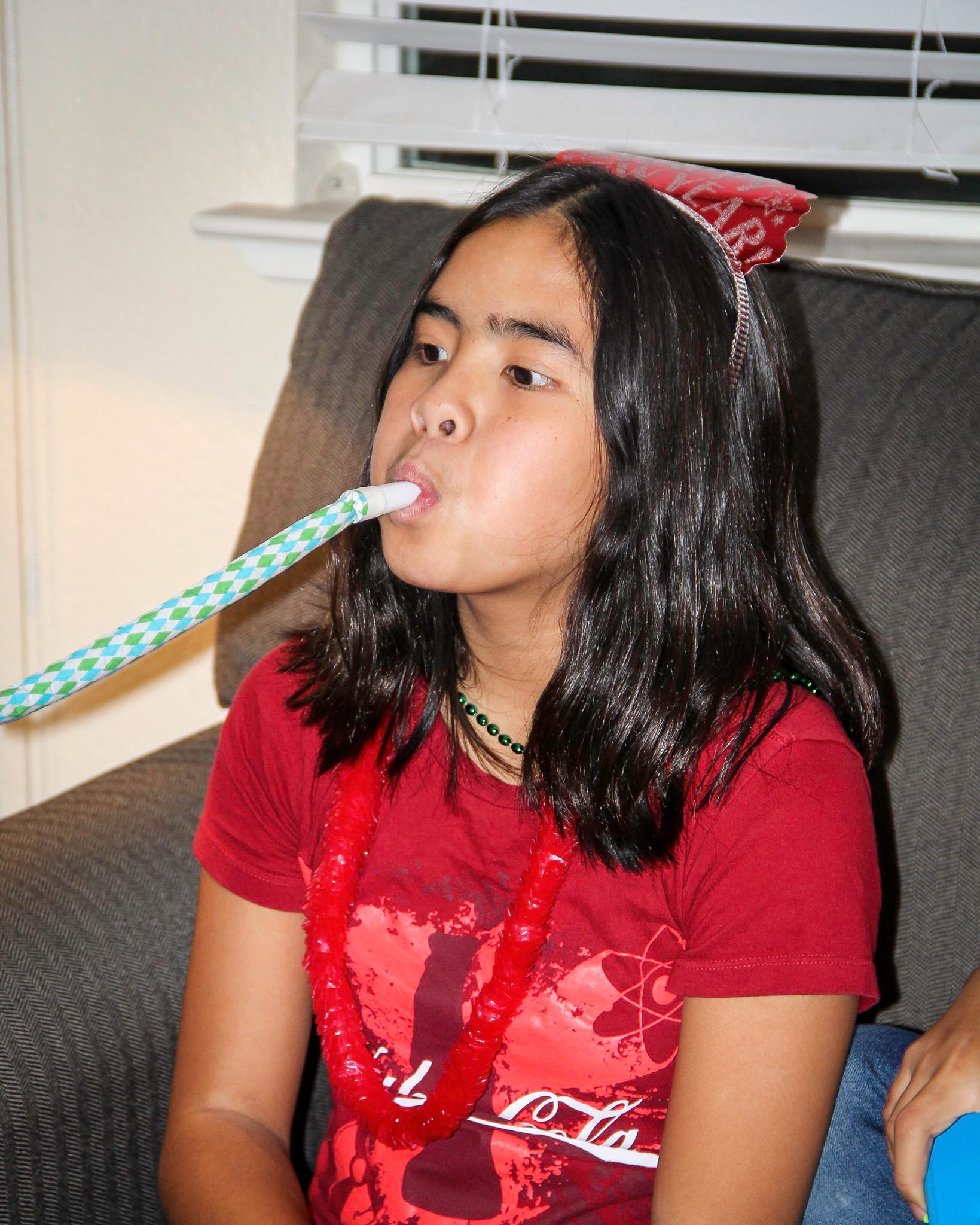 Calista blowing noisemaker on New Year's Eve.